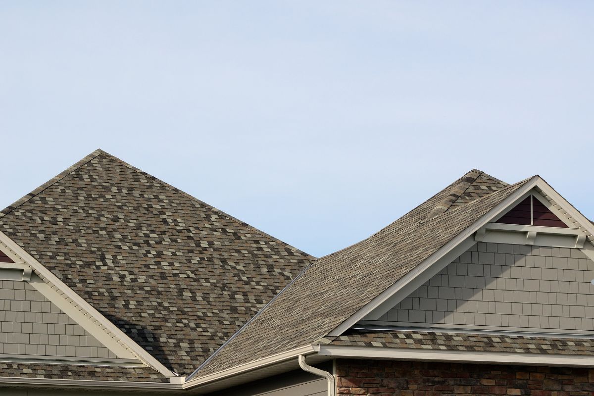 Gable roof featuring two distinct colors of shingles, showcasing a unique and contrasting design.